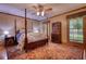 Inviting bedroom showcasing a canopy bed, decorative rug, and natural light for a tranquil retreat at 2165 Robin Hood Trl, Cumming, GA 30040