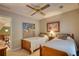 Cozy bedroom featuring twin beds with wood frames and a ceiling fan at 2165 Robin Hood Trl, Cumming, GA 30040
