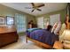 Bright bedroom with neutral tones, a wooden bed, and large window at 2165 Robin Hood Trl, Cumming, GA 30040