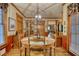 Cozy dining room featuring hardwood floors, chair rail molding, and a modern light fixture above a round table at 2165 Robin Hood Trl, Cumming, GA 30040