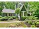 Attractive home with a manicured lawn, bay windows, and shutters, surrounded by lush trees at 2165 Robin Hood Trl, Cumming, GA 30040