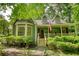 Charming home featuring a covered porch, bay window, and mature landscaping at 2165 Robin Hood Trl, Cumming, GA 30040