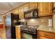 This traditional kitchen features granite counters, stainless steel appliances and warm-toned wood cabinets at 2165 Robin Hood Trl, Cumming, GA 30040