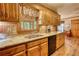 Kitchen with wooden cabinets, granite counters, and wood floors at 2165 Robin Hood Trl, Cumming, GA 30040