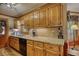 Traditional kitchen with wood cabinets, granite countertops, and modern appliances at 2165 Robin Hood Trl, Cumming, GA 30040