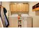 Functional laundry room with ample cabinet space, washer, dryer, and organized storage solutions at 2165 Robin Hood Trl, Cumming, GA 30040