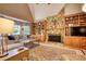 Bright living area with a stone fireplace, built-in cabinets, and large windows at 2165 Robin Hood Trl, Cumming, GA 30040