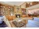 Cozy living room with a stone fireplace, built-in bookshelves, and a view of the upstairs landing at 2165 Robin Hood Trl, Cumming, GA 30040