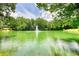 Scenic pond with fountain, surrounded by lush trees at 2165 Robin Hood Trl, Cumming, GA 30040