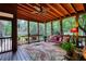 Relaxing screened porch with wood ceiling, ample seating, and a decorative rug for added comfort at 2165 Robin Hood Trl, Cumming, GA 30040