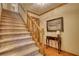 Carpeted staircase featuring wood trim and a decorative table with a lamp at 2165 Robin Hood Trl, Cumming, GA 30040