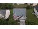 Aerial view of a two-story home with a well-maintained lawn, mature trees, and a driveway leading to an attached garage at 3292 Shady Valley Ct, Loganville, GA 30052