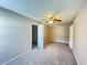 Spacious bedroom featuring neutral-toned walls, plush carpeting, ceiling fan and a large closet at 3292 Shady Valley Ct, Loganville, GA 30052
