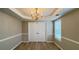 Charming dining room featuring modern flooring, neutral walls, and a classic chandelier fixture at 3292 Shady Valley Ct, Loganville, GA 30052