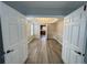 Dining room with gray flooring, a chandelier, white wainscotting and open doors leading to an eat-in kitchen at 3292 Shady Valley Ct, Loganville, GA 30052