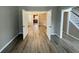 Bright dining room featuring open doorways to a kitchen and hallway, and newly installed gray flooring at 3292 Shady Valley Ct, Loganville, GA 30052