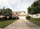 Inviting exterior view of a two-story home with a spacious driveway and lush green landscaping at 3292 Shady Valley Ct, Loganville, GA 30052
