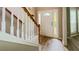 Bright foyer featuring wood floors, white staircase, and a front door with decorative glass at 3292 Shady Valley Ct, Loganville, GA 30052