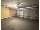 Large garage with a roll up door and two ceiling fans at 3292 Shady Valley Ct, Loganville, GA 30052