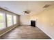 Bright living room features large windows, a ceiling fan, and a fireplace with mantle at 3292 Shady Valley Ct, Loganville, GA 30052