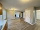 Spacious living area with hardwood floors flowing from the kitchen to a fireplace, and lots of natural light at 3292 Shady Valley Ct, Loganville, GA 30052