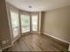 Bright, empty room features new gray flooring, fresh neutral paint, and a bay window that lets in light at 3292 Shady Valley Ct, Loganville, GA 30052
