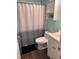 This bathroom features a toilet, sink, wooden floor, a shower with a curtain, and a small storage space above the toilet at 40 Legend Creek, Douglasville, GA 30134