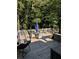 Serene outdoor deck featuring comfortable seating, string lights, and a peaceful wooded view at 40 Legend Creek, Douglasville, GA 30134