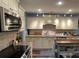 Well-equipped kitchen with granite counters, light cabinets, stainless appliances, and tile backsplash at 40 Legend Creek, Douglasville, GA 30134