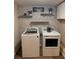 Functional laundry room with washer, dryer, and decorative shelving, perfect for organization at 40 Legend Creek, Douglasville, GA 30134