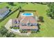 Aerial view showcases a pool, expansive yard, and the home's architectural design at 161 Honey Creek Rd, Mcdonough, GA 30252