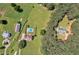Large acreage property with a house, pool, outbuildings, pasture, and mature trees from above at 161 Honey Creek Rd, Mcdonough, GA 30252