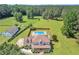 Sprawling property with a private in-ground pool, large lawn, and surrounding mature trees at 161 Honey Creek Rd, Mcdonough, GA 30252