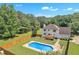 Backyard oasis features an in-ground pool and a deck with views of the surrounding landscape at 161 Honey Creek Rd, Mcdonough, GA 30252