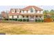 Charming two-story home with a welcoming front porch and well-manicured landscaping at 161 Honey Creek Rd, Mcdonough, GA 30252