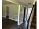 Hallway featuring hardwood floors, white trim, and neutral paint at 161 Honey Creek Rd, Mcdonough, GA 30252