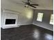 Living room featuring hardwood floors, fireplace with tile, and natural lighting at 161 Honey Creek Rd, Mcdonough, GA 30252