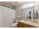 Functional bathroom featuring a vanity with storage, a toilet, and a shower with curtain, providing essential amenities at 2642 Bridgehampton Sw Rd, Marietta, GA 30064