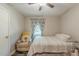 Bright bedroom features a chair, a single bed, a patterned rug, and plenty of natural light at 2642 Bridgehampton Sw Rd, Marietta, GA 30064