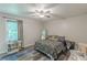 Spacious bedroom with wood-look flooring, a queen-sized bed, bright light from the window, and neutral walls at 2642 Bridgehampton Sw Rd, Marietta, GA 30064