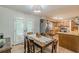 Dining area with hardwood floors, a wooden table, and access to the outdoor patio at 2642 Bridgehampton Sw Rd, Marietta, GA 30064