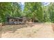 Exterior view of a cozy two-story home with fenced yard and an inviting fire pit area at 2642 Bridgehampton Sw Rd, Marietta, GA 30064