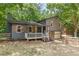 Charming two-story home with a cozy front porch, wooden shutters, and attached garage at 2642 Bridgehampton Sw Rd, Marietta, GA 30064