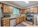 Kitchen area featuring stainless steel appliances, wood cabinets, and natural light at 2642 Bridgehampton Sw Rd, Marietta, GA 30064