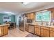 Updated kitchen with wood cabinets, stainless steel appliances, and an adjacent dining area at 2642 Bridgehampton Sw Rd, Marietta, GA 30064