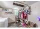 A well-lit laundry room with a washer, dryer, shelves, and clothing rack at 2642 Bridgehampton Sw Rd, Marietta, GA 30064