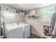 Laundry room equipped with a washer and dryer plus storage shelves at 2642 Bridgehampton Sw Rd, Marietta, GA 30064