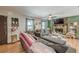 Comfortable living room featuring a stone fireplace, ceiling fan, and hardwood floors at 2642 Bridgehampton Sw Rd, Marietta, GA 30064