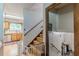Well-lit staircase with wood treads and a secure baby gate, connecting the home's levels with safety and style at 2642 Bridgehampton Sw Rd, Marietta, GA 30064