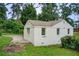 White brick home with windows surrounded by grass, trees, and an empty concrete pad at 2742 Alpine Rd, Atlanta, GA 30305